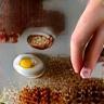 Close up image of hands carefully mixing ingredients in a small bowl.